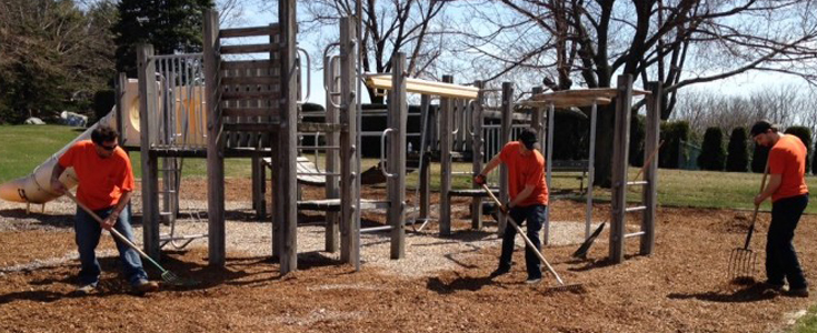 UMT Public Works Crew spreading fresh mulch at Township playground